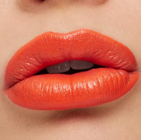 MAC Ximal lipstick lip swatch on arm highlighting true Morange payoff and smooth satin finish benefit