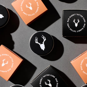 Mad Rabbit lifestyle image using balm outdoors for skin protection
