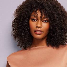 Madison Reed after‑wash curly hair lifestyle shot showing defined, frizz‑controlled results