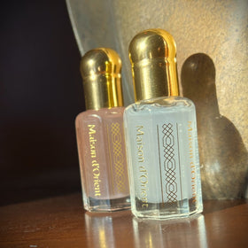 Maison d'Orient bottles inside a handbag, illustrating portable fragrance benefit