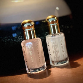 Maison d'Orient bottle next to coin for size comparison and portability