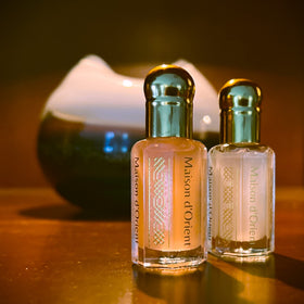 Maison d'Orient bottles beside a coin, showing compact 6 mL size benefit