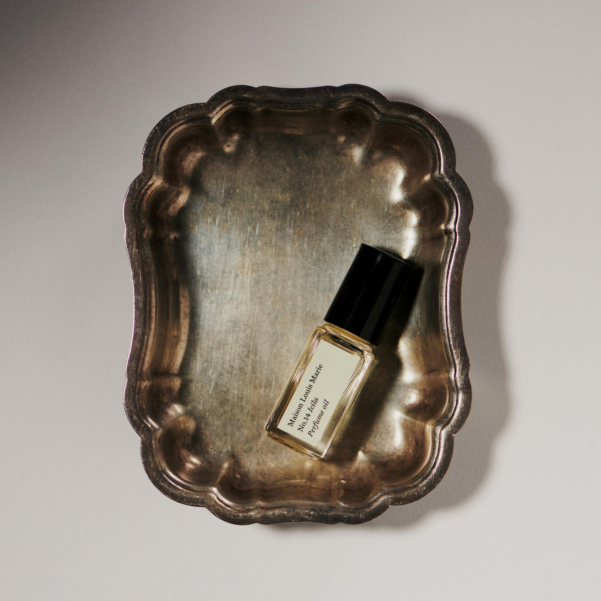 Maison Louis Marie Icila roll-on in a travel setting showing portability and everyday use