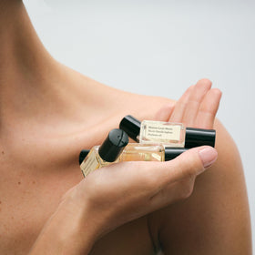Maison Louis Marie roll-on in hand lifestyle image showing portable touch-up benefit