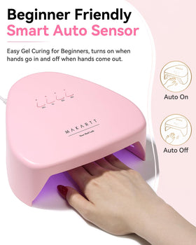 Makartt lamp beside a hand to show compact scale and travel-friendly size
