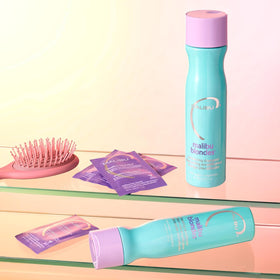 Malibu C conditioner being applied to mid-lengths to reduce tangles