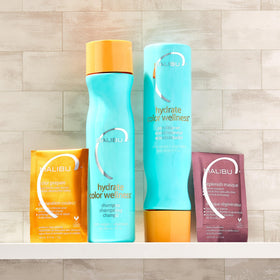 Malibu C conditioner being applied in shower illustrating detangling and hydration