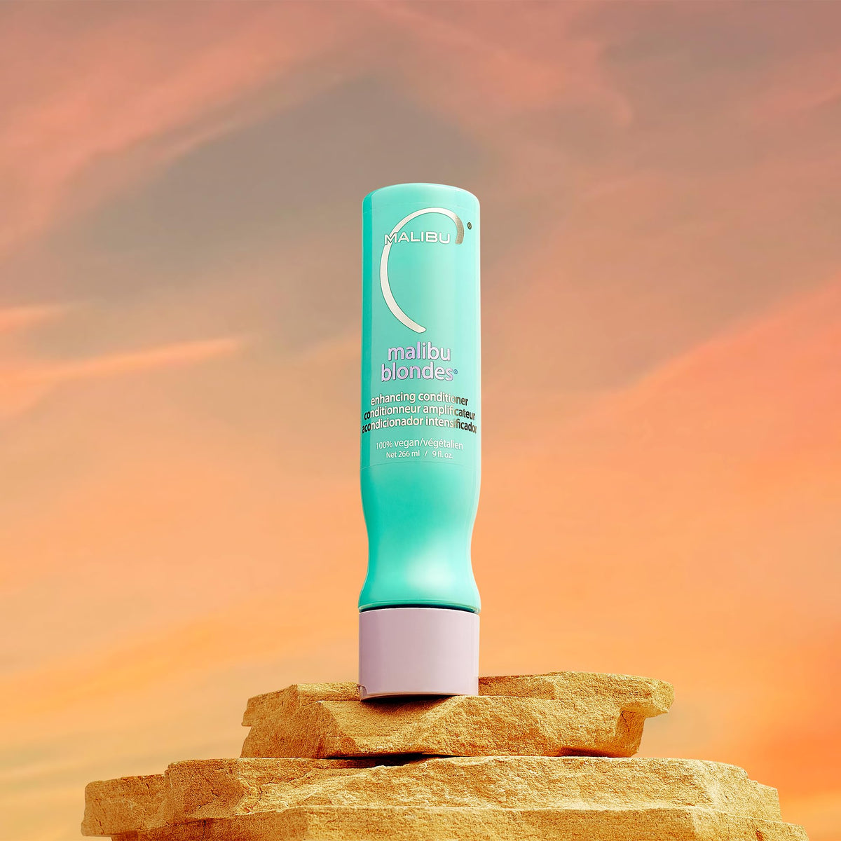 Malibu C 9 oz conditioner beside common bottle to show true scale
