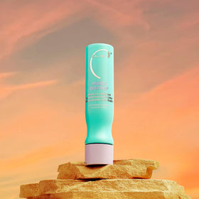 Malibu C 9 oz conditioner beside common bottle to show true scale