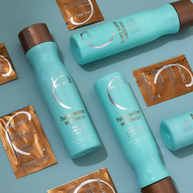 Malibu C bottle on bathroom shelf in lifestyle setting promoting salon results