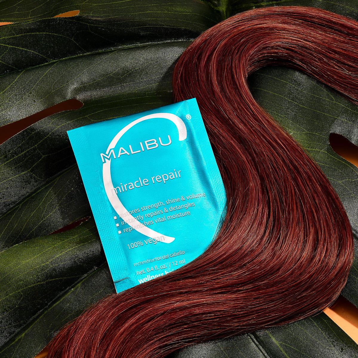 Malibu C under processing cap in salon setting, demonstrating intensified heat-boost benefit