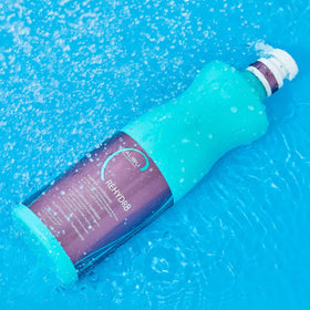 Malibu C conditioner texture pouring from bottle showing creamy hydration and spreadability