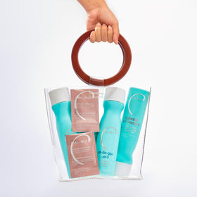 Malibu C bottles for scale in hand illustrating kit size and travel-friendly benefit