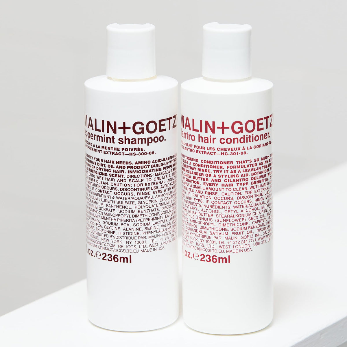 Malin + Goetz bottle next to ruler showing 8 fl oz size for scale and travel planning