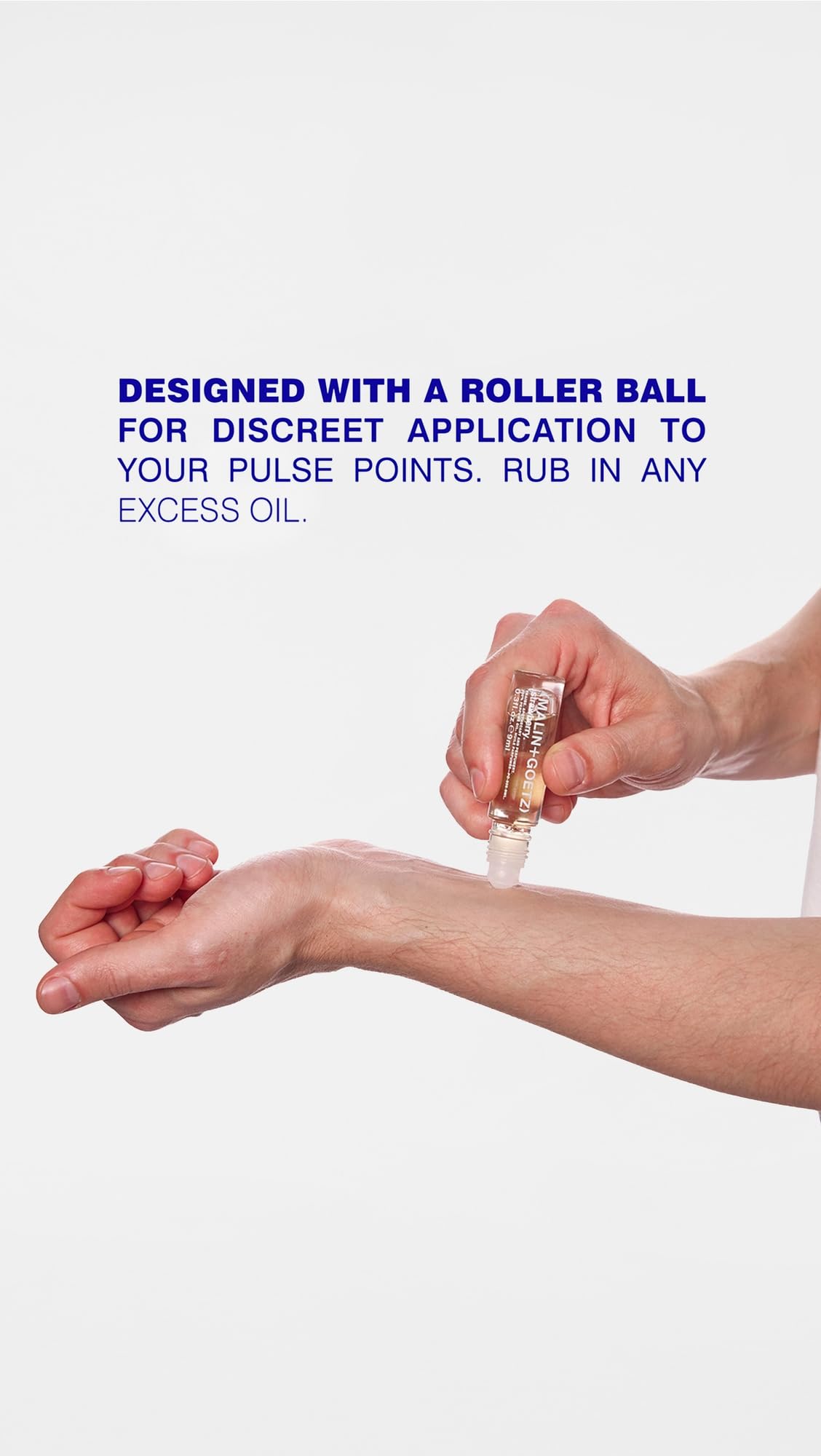 MALIN+GOETZ Dark Rum rollerball held in hand for travel-friendly use benefit