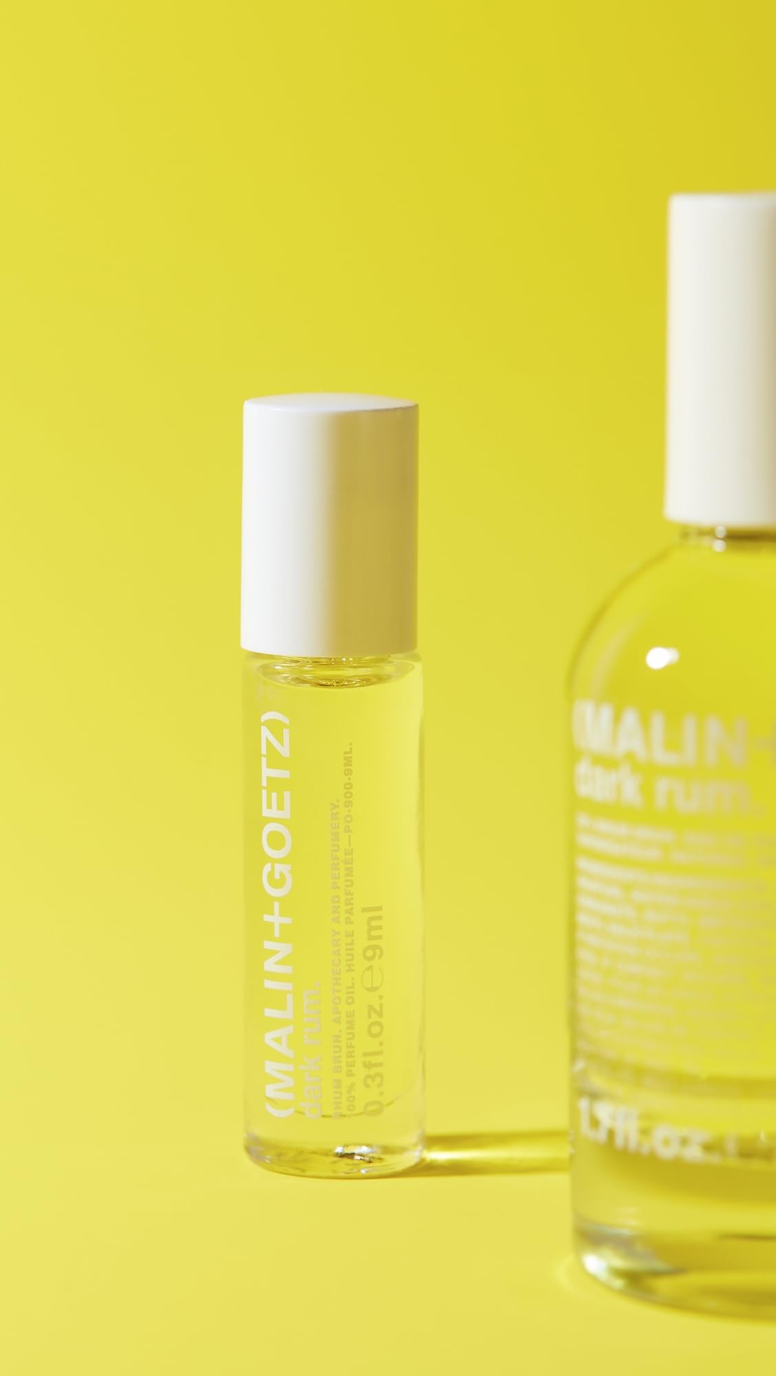MALIN+GOETZ Dark Rum next to keys in pocket illustrating compact, travel benefit