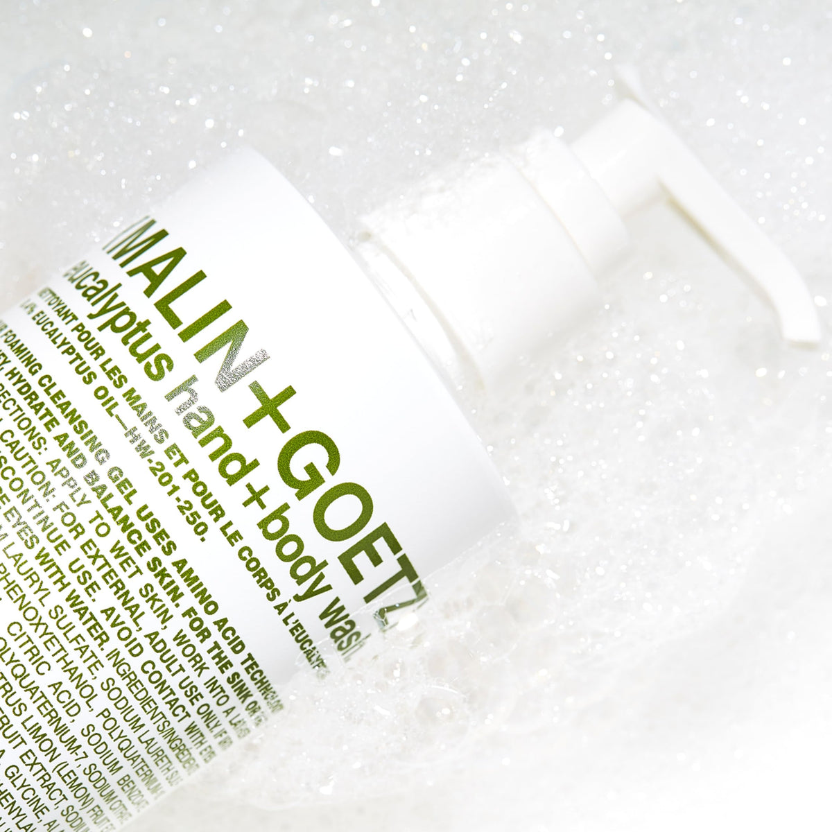 MALIN+GOETZ bottle in shower setting illustrating refreshing use