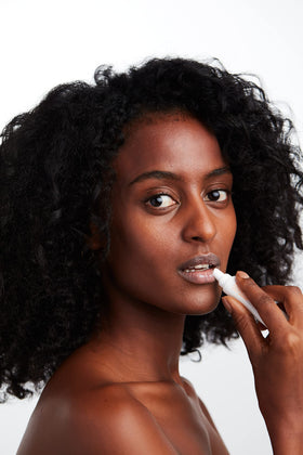MALIN+GOETZ label detail highlighting titanium dioxide SPF and ingredient benefits
