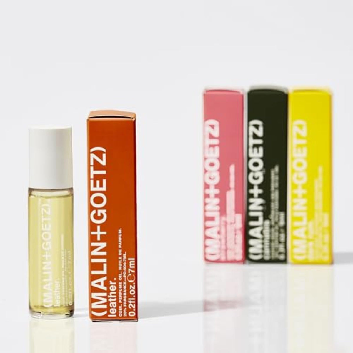 MALIN+GOETZ rollerball tucked in a bag pocket conveying travel convenience and daily touch-up ease