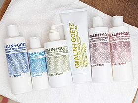 MALIN+GOETZ jar styled on bathroom counter suggesting everyday routine use