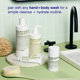 MALIN+GOETZ lotion on bathroom counter in lifestyle scene suggesting daily ritual and subtle bergamot scent
