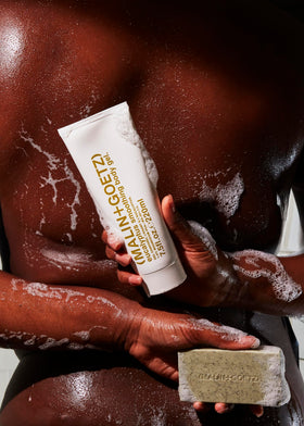MALIN+GOETZ bar creating creamy lather in shower, shows gentle cleansing action