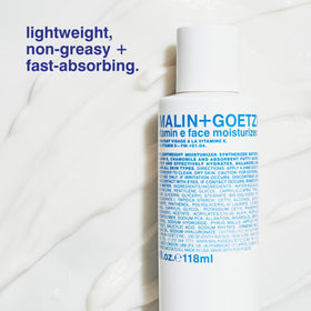 MALIN+GOETZ moisturizer on hand showing fast-absorbing hydration
