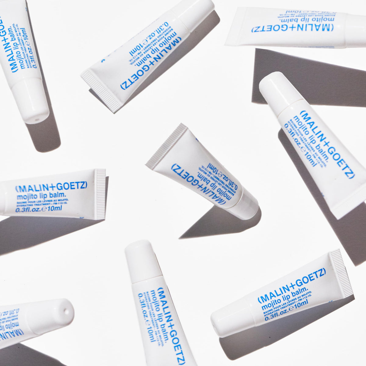 MALIN+GOETZ lifestyle image outdoors protecting lips from wind and dryness