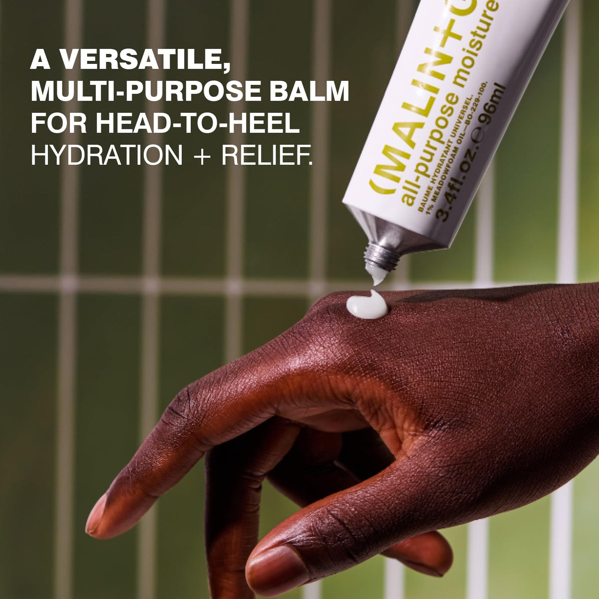 MALIN+GOETZ open tube close-up showing balm texture and easy application benefit