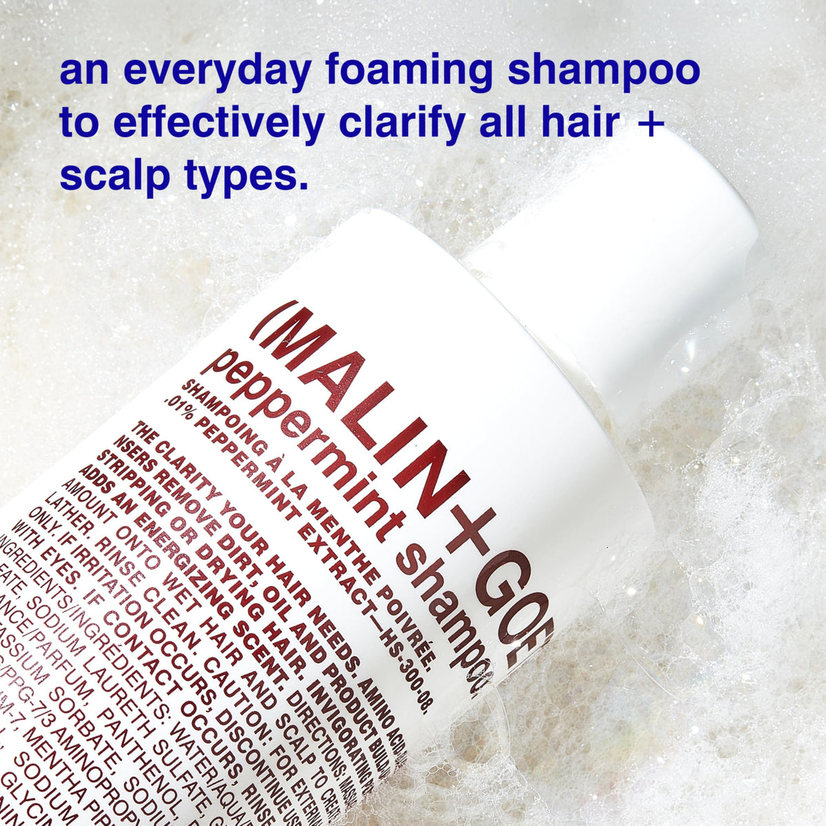 MALIN+GOETZ shampoo in shower being applied to scalp for invigorating cleanse