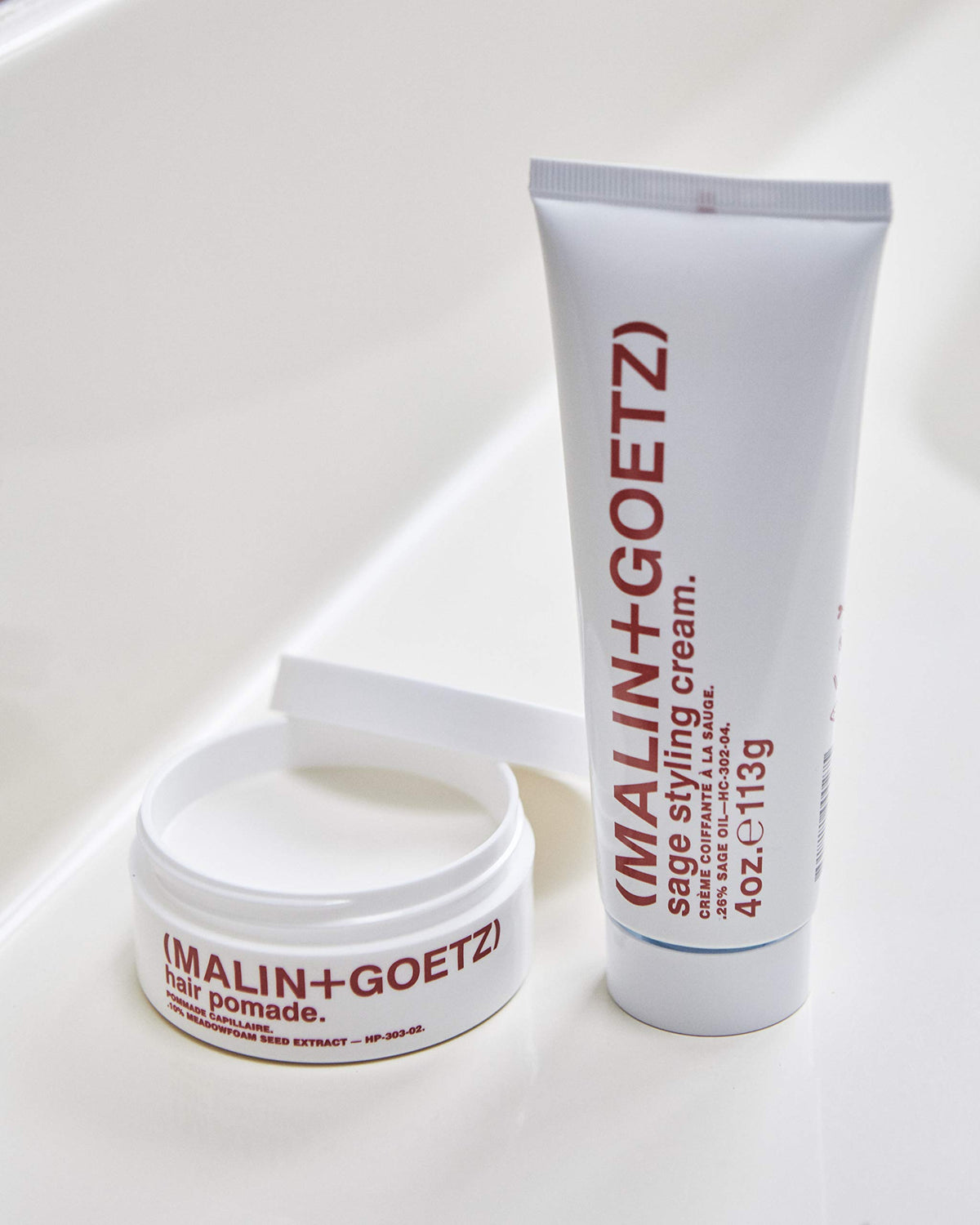 MALIN+GOETZ label detail highlighting beeswax and meadowfoam oils