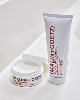 MALIN+GOETZ label detail highlighting beeswax and meadowfoam oils