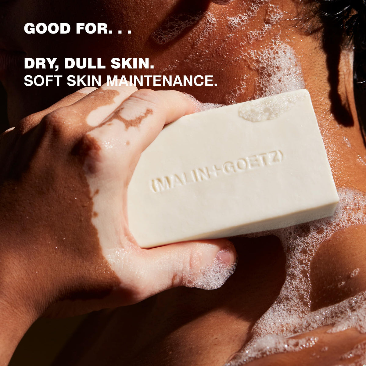 MALIN+GOETZ hydrating bar held in hand for scale, illustrating compact size and dense feel