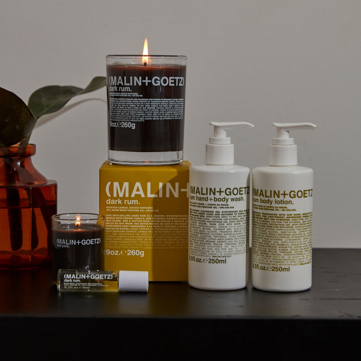 MALIN+GOETZ lotion held in hand for scale showing travel-friendly 8.5 fl oz benefit