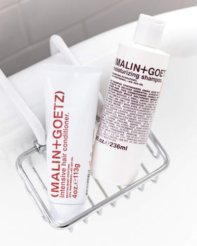 MALIN+GOETZ bottle beside conditioner in bathroom setting for a balanced routine