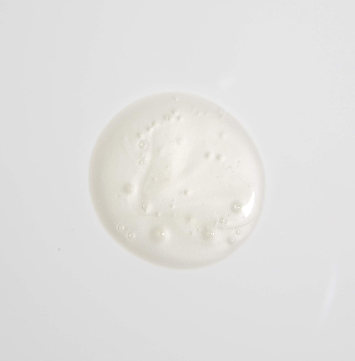 MALIN+GOETZ shampoo in hand creating gentle lather to indicate easy cleansing