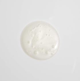MALIN+GOETZ shampoo in hand creating gentle lather to indicate easy cleansing