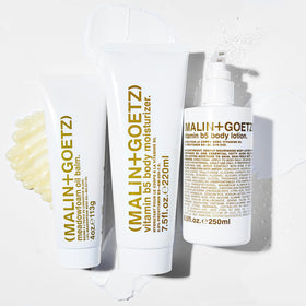 MALIN+GOETZ bottle next to hands for scale and practical everyday use benefit