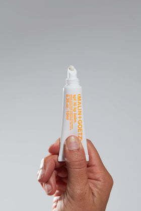 MALIN+GOETZ close-up of balm texture with sheer finish for smooth hydration