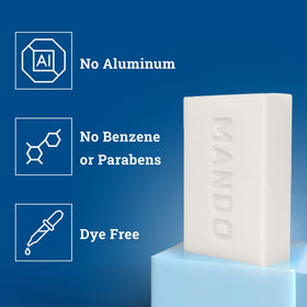 Mando cleansing bar held in hand showing size and travel-friendly benefit