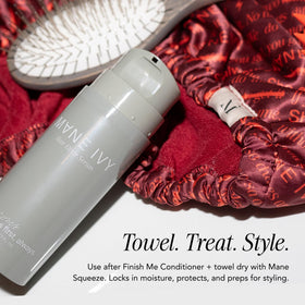 MANE IVY bottle on bathroom vanity styled with towels conveying daily routine benefit