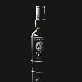 Mane Tame oil texture drop on hand highlighting non-greasy absorption benefit