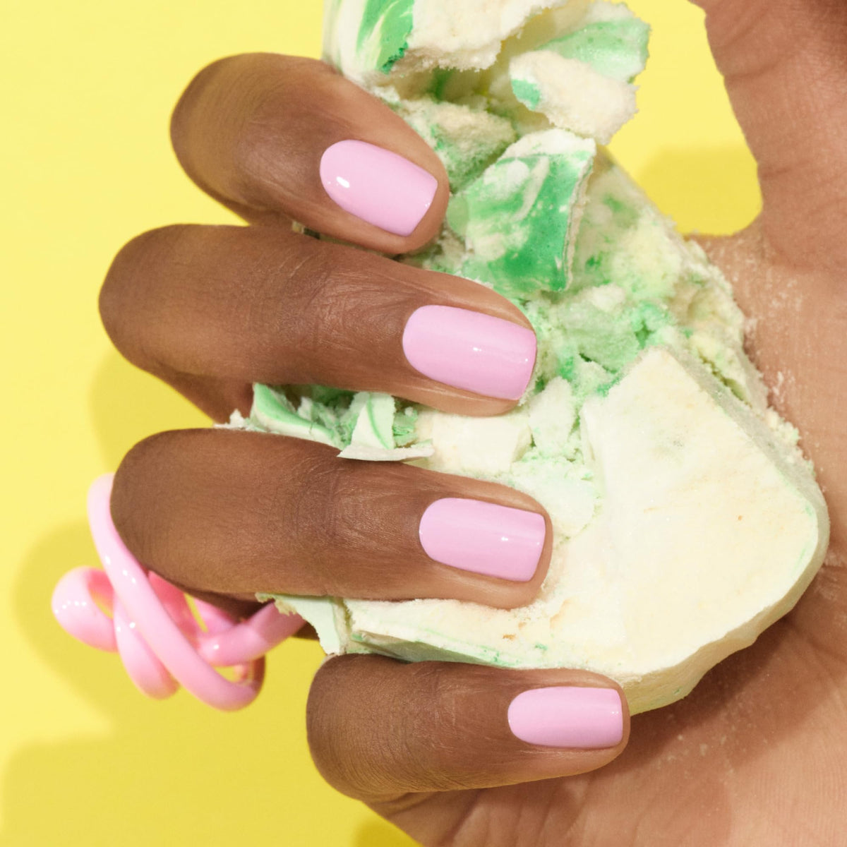 Manucurist swatch on fingernails showing opaque neon pink wear and shine