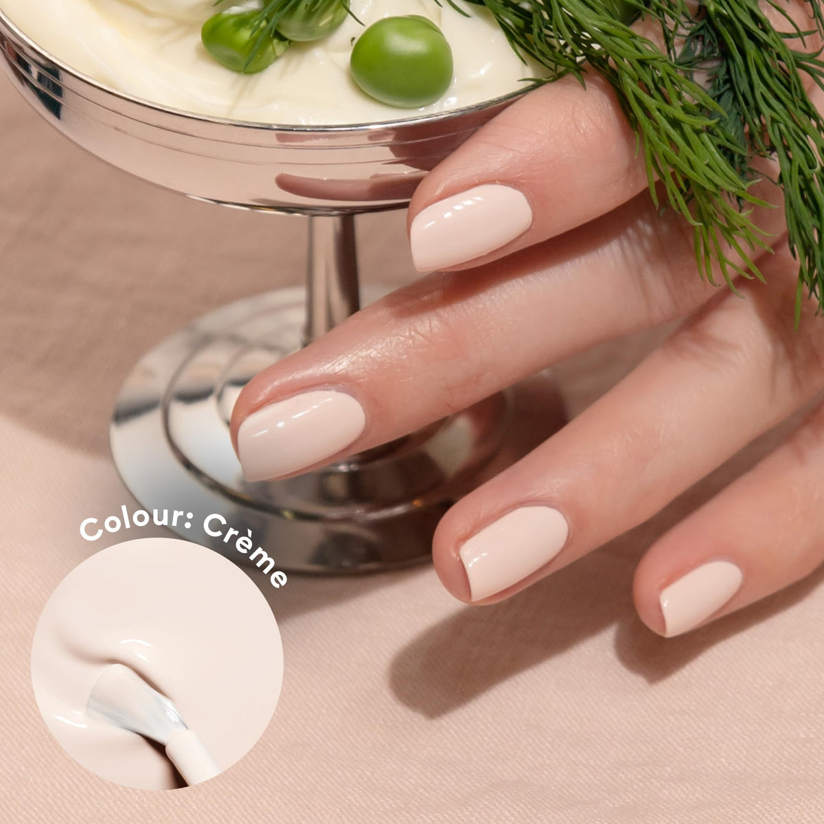 Manucurist brush spreading off-white polish highlighting smooth application benefit