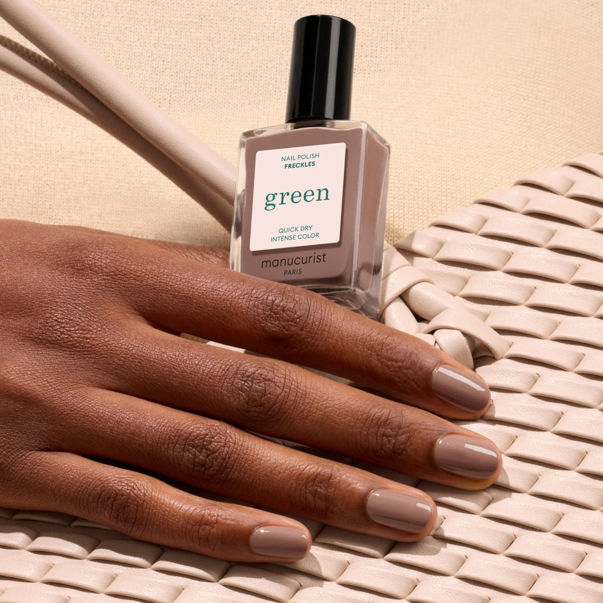 Manucurist swatch on hand showing Freckles brown tone and natural, opaque coverage
