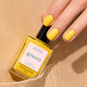 Manucurist Gold Button swatch on fingernails showing vivid opaque yellow finish