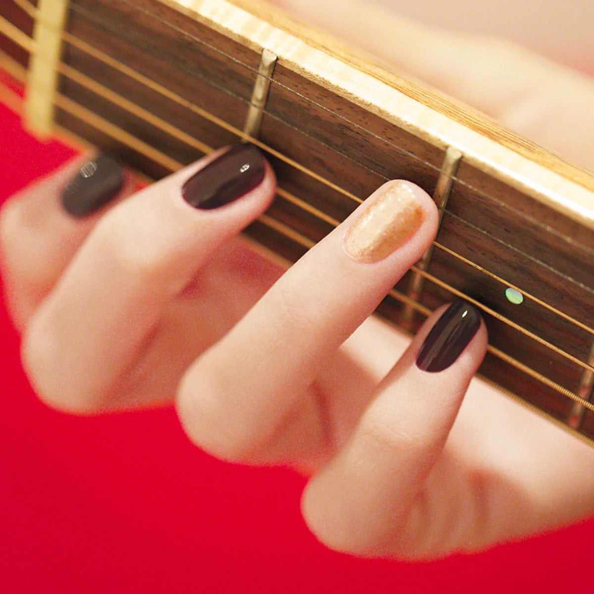 Manucurist swatch on fingertips demonstrating opaque coverage benefit