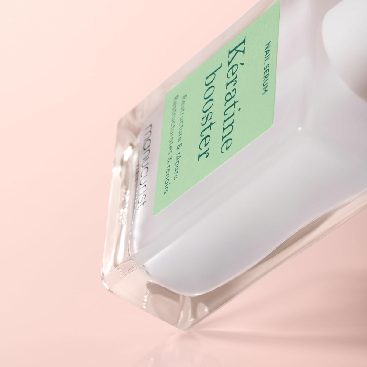 Manucurist bottle next to ruler showing product size and travel-friendly benefit