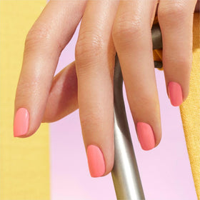 Manucurist Pop swatch on skin showing opaque pink color payoff and vivid orange undertones