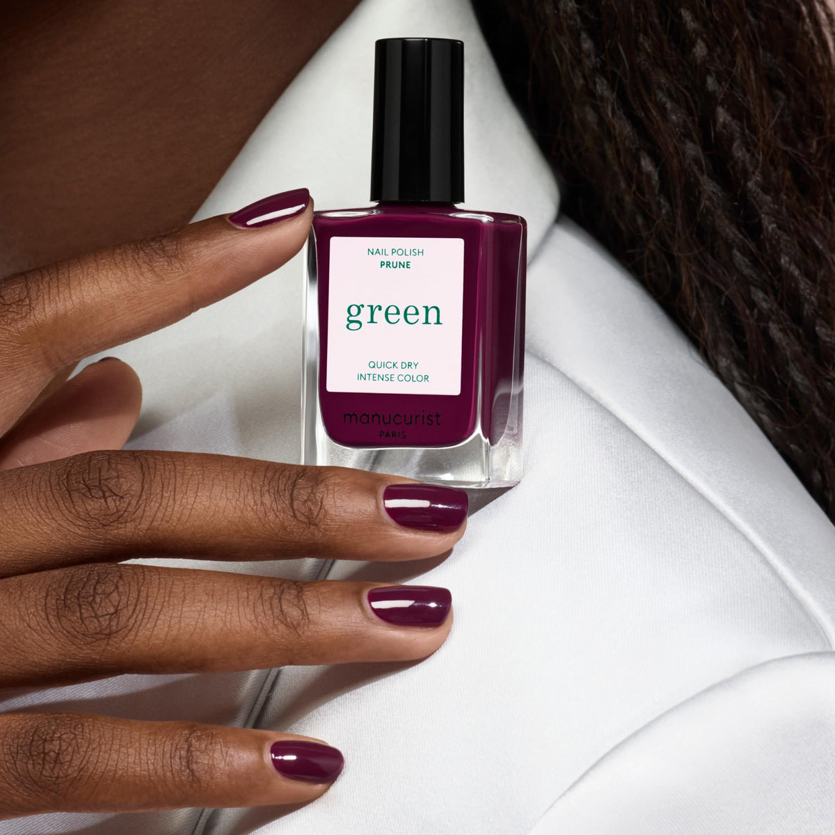 Manucurist swatch on fingers displaying deep red-wine color and opaque finish